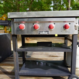 Camp Chef Flat top gas grill 4 burners on wheels, has a homemade stainless still cover
